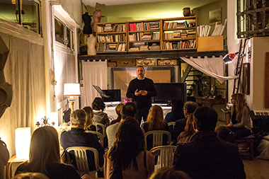 Don Luigi mentre guida una serata di rilessione con i suoi amici artisti